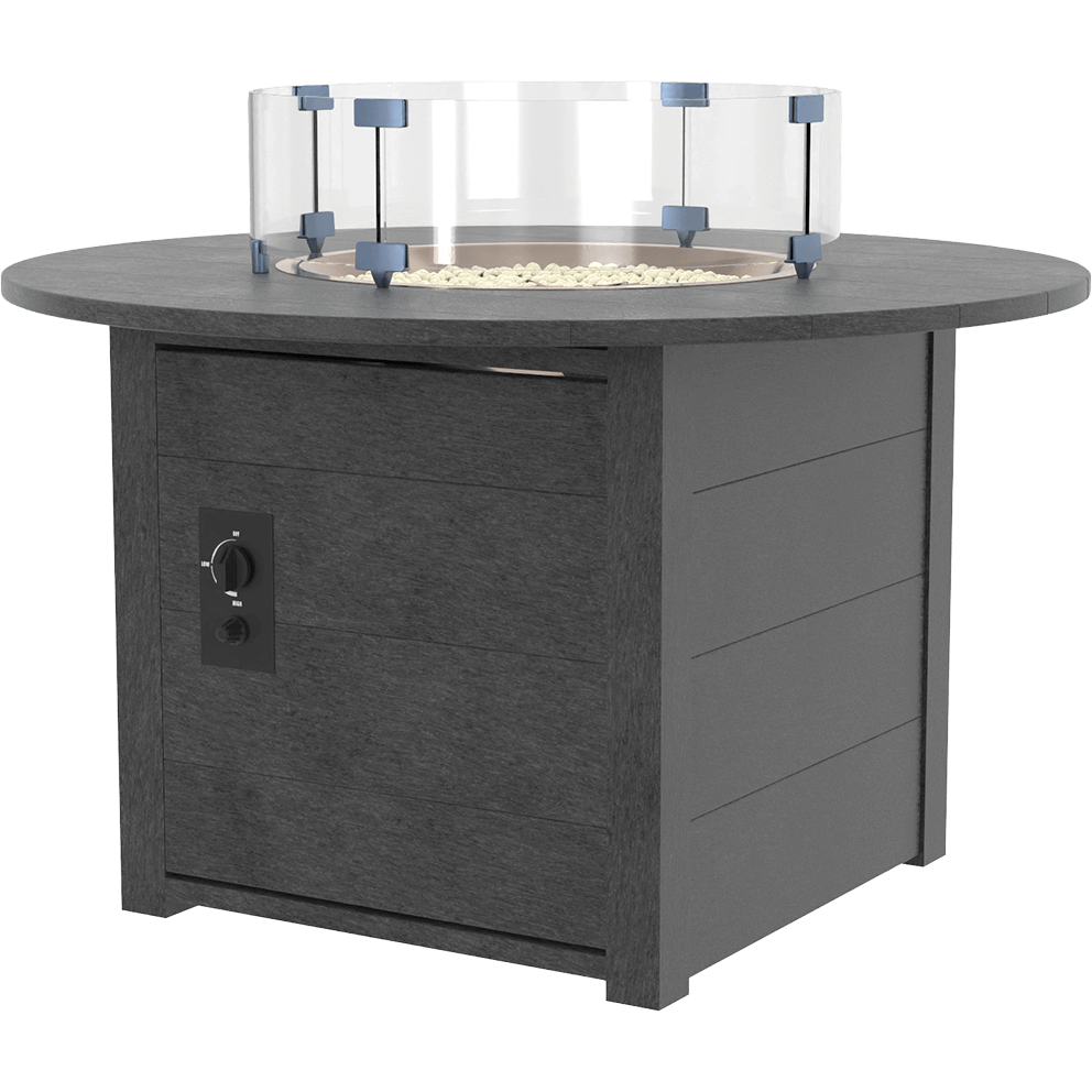 A clean angled product view of the CRP Round Fire Table isolated on a white background. The circular charcoal grey tabletop is supported by a sturdy square base made from recycled plastic boards with a realistic wood grain texture. A clear round glass wind guard sits securely above the recessed burner area, which is filled with reflective fire glass. The control panel is visible on the side of the base, highlighting the push button ignition and heat control. This isolated view shows the overall structure, materials and craftsmanship of the round fire table.