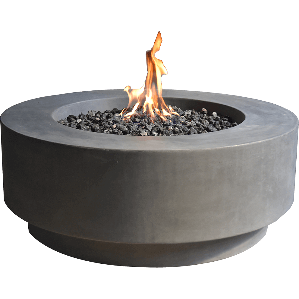 Studio-style front view of the Ross Fire Table isolated on a transparent background, showing the clean geometric silhouette of the wide circular body in light-grey smooth concrete. The upper surface frames a recessed fire bowl packed with dark lava rocks surrounding a stainless-steel burner that produces tall, bright flames rising sharply. The lower tiered base subtly recedes inward, giving the table a floating appearance. No branding is visible, and all components including the burner, lava media, and structural cementitious body are clearly defined to support accurate visual reference for both the LP and natural-gas versions of the product.