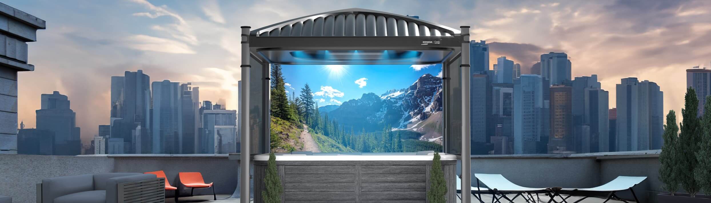 Covana Oasis Midnight automated hot tub cover installed on a rooftop terrace, shown fully raised over a square spa with a dark grey composite cabinet. The sleek black ribbed roof and matte black frame create a modern, elegant look. Inside, soft blue LED lights illuminate the space, while the scenic Rockies privacy screen displays a sunlit mountain trail with evergreen trees. The terrace is surrounded by modern skyscrapers under a partly cloudy sunset sky, with patio seating and greenery enhancing the upscale urban setting.