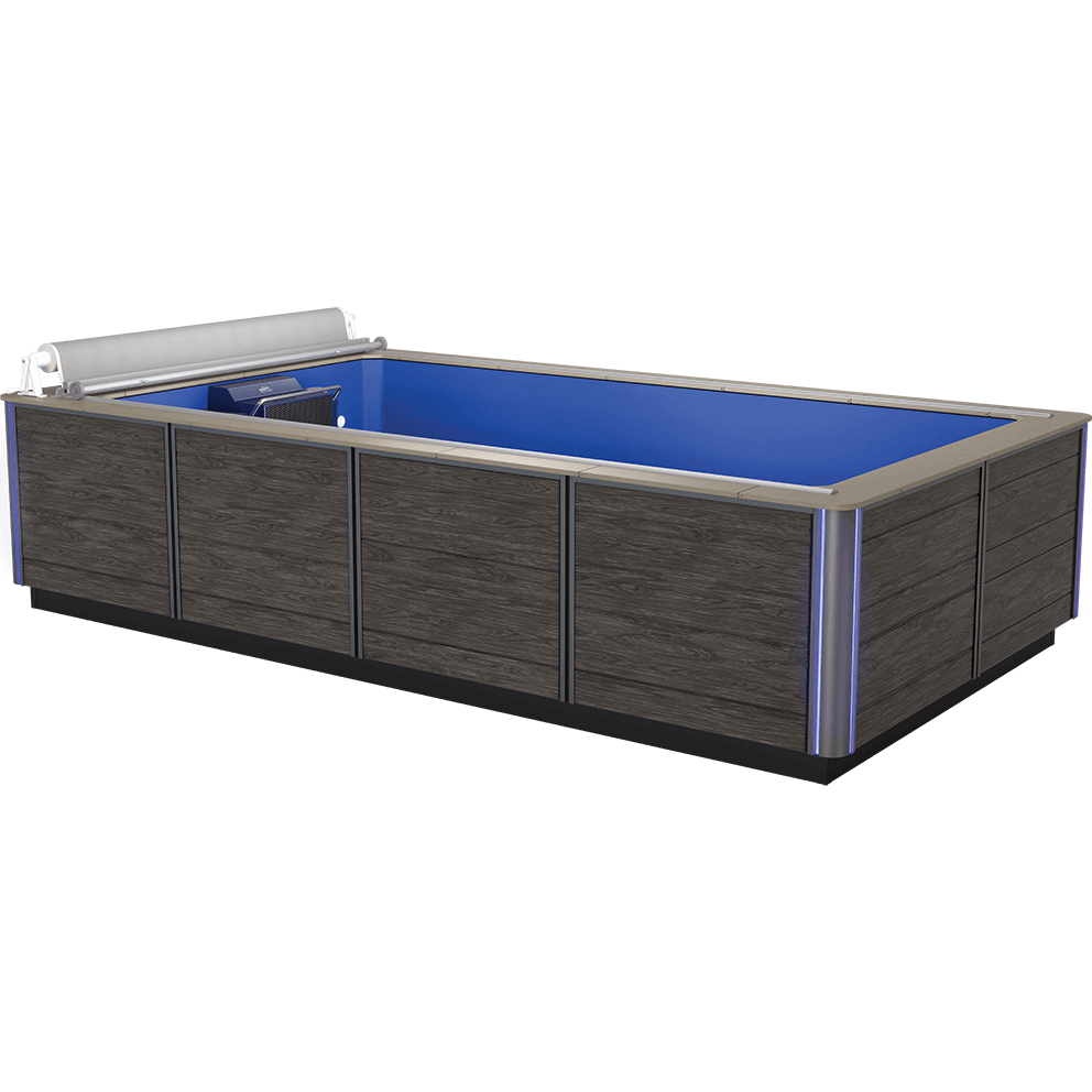 High-performance Endless Pools EP508 Pro Modular Pool with Hydrodrive™ Pro Technology, viewed from the front-left corner at a slight downward angle. The exterior is clad in horizontally grained, dark wood-effect panelling divided into vertical sections by slim brushed-aluminium trim strips. Two vertical corner trims house subtle, cool-blue LED lighting that runs the full height of the pool’s corners. The top edge is bordered with a brushed-aluminium coping frame. Inside, the pool features a vibrant blue interior shell with a smooth, uninterrupted swim lane. At the far end, a fully retracted silver roll-up cover housing sits above the precision-engineered swim current unit with a prominent intake grille and control panel. The front perimeter shows no obstructions, highlighting the open swim zone.