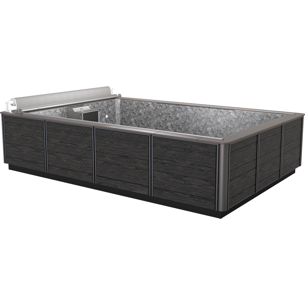 Front angled exterior view of the Endless Pools EP510 Modular Pool, showcasing its sleek black composite cabinet panels with subtle woodgrain texture framed by metallic trim, surrounding a spacious rectangular swim area lined with a light grey marbled interior. The integrated Hydrodrive™ swim current system is positioned at one end beneath a neatly rolled-up automatic pool cover, with surrounding decking framing the perimeter.