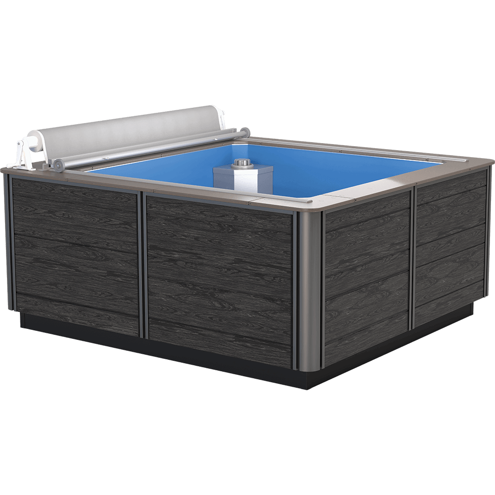 Endless Pools Plunge Mini Therapy Pool front view showing the compact, square 7-foot by 7-foot design with deep blue interior shell. Surrounding cabinet panels feature sleek black wood-grain finish framed by brushed stainless steel corner trim. The top edge is outlined in a smooth, light-grey coping, with an integrated manual roller cover system mounted along the rear edge. The interior contains a central silver cube-shaped mount positioned near the back wall for optional current or treadmill equipment, set against the smooth blue pool floor.