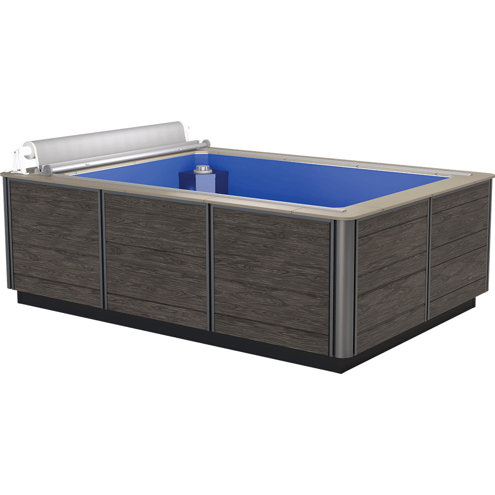 Front angled view of the Endless Pools Plunge Prime Therapy Pool, showing the compact rectangular design with dark grey wood-effect side panelling framed by vertical silver aluminium corner posts. The smooth beige coping runs around the pool edge. The partially retracted white slatted pool cover is housed in a low roller system mounted along the far end. The vibrant blue interior contrasts with the exterior, with the water return housing visible at the far right corner inside the pool.