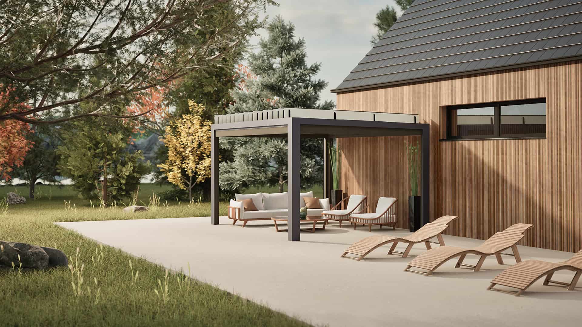 The Stella Open Air Pergola installed in a backyard, placed adjacent to a wooden-panelled modern house. The pergola features a sleek dark frame with motorised louvres. Beneath it sits an outdoor lounge arrangement with a white sectional sofa, two matching chairs, and a coffee table. The patio extends outward with wooden slatted sun loungers, while the background shows trees with autumn foliage and a large overhanging branch to the left.