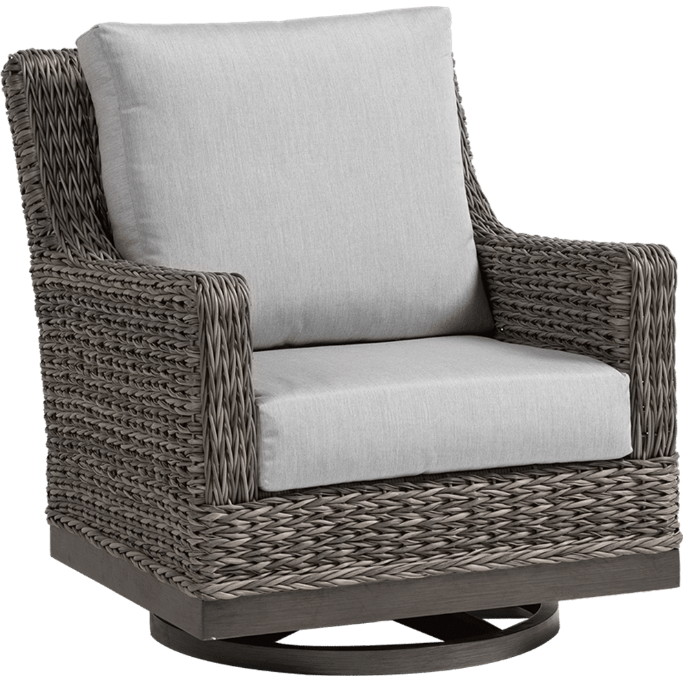 Angled front-side view of the Asheville Swivel Gliding Club Chair from the Asheville Furniture Collection, featuring a deep, square silhouette crafted from tightly woven resin wicker in a warm grey tone. The chair includes a thick, light grey seat cushion and a tall, matching back cushion, both with tailored edges. The straight arms and full woven side panels extend down to a solid dark wood-look base, which houses the sturdy circular swivel gliding mechanism, providing smooth 360-degree movement and rocking motion.
