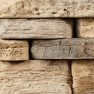 Close-up of the Fon Du Lac colour option, showing stacked stones in warm beige and soft taupe tones with subtle grey highlights. The rough-hewn surface features organic texture and light weathering, evoking the natural look of limestone or aged sandstone.