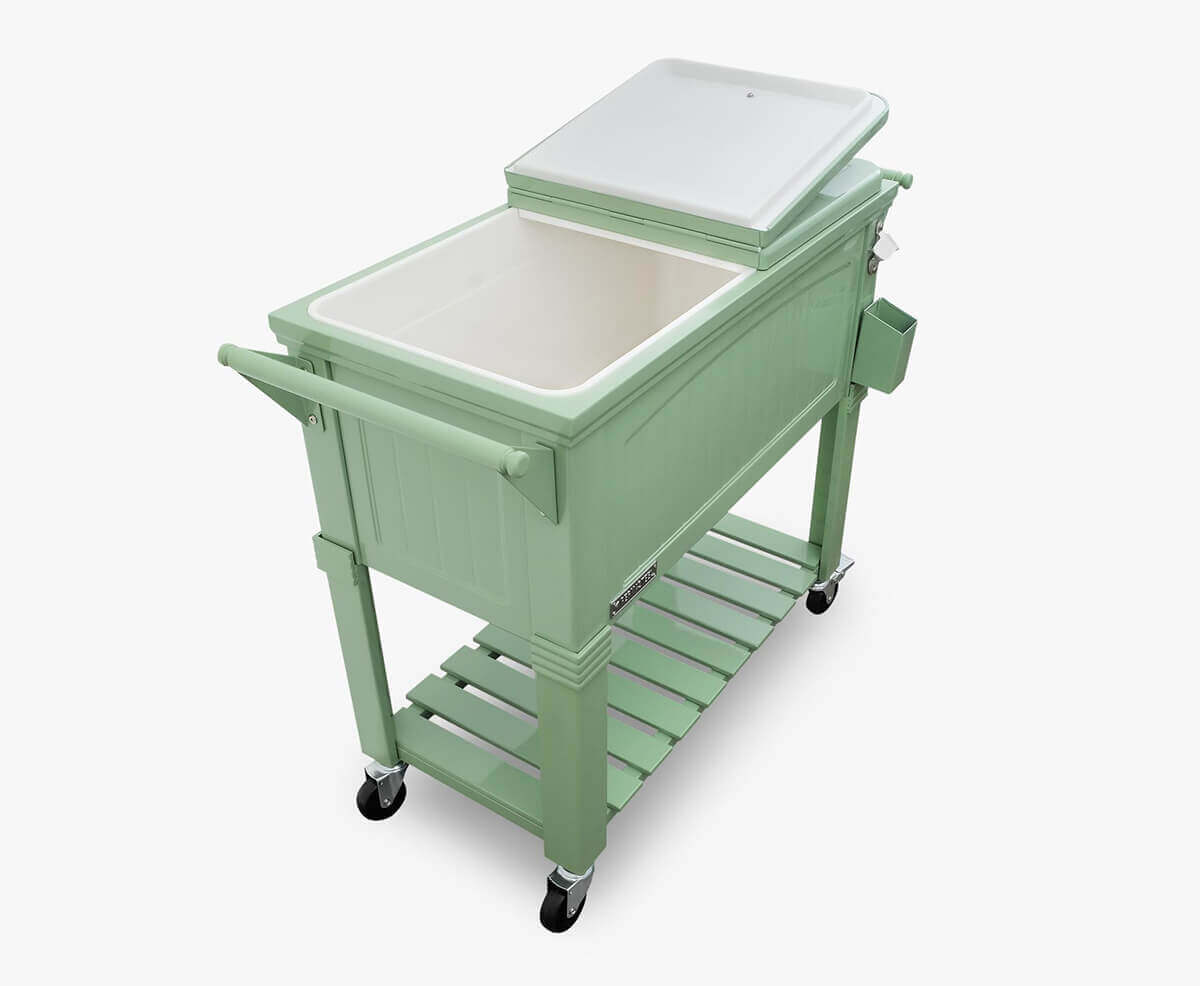 Top-down perspective of the Permasteel 80qt Furniture Style Cooler in mint green with one lid open, revealing a deep insulated white interior. The slatted lower shelf, large side handles, and chrome detailing on the lid knobs are visible. The composition highlights the cooler’s spacious basin and balanced proportions, designed for convenient access and effortless entertaining in elegant outdoor spaces.