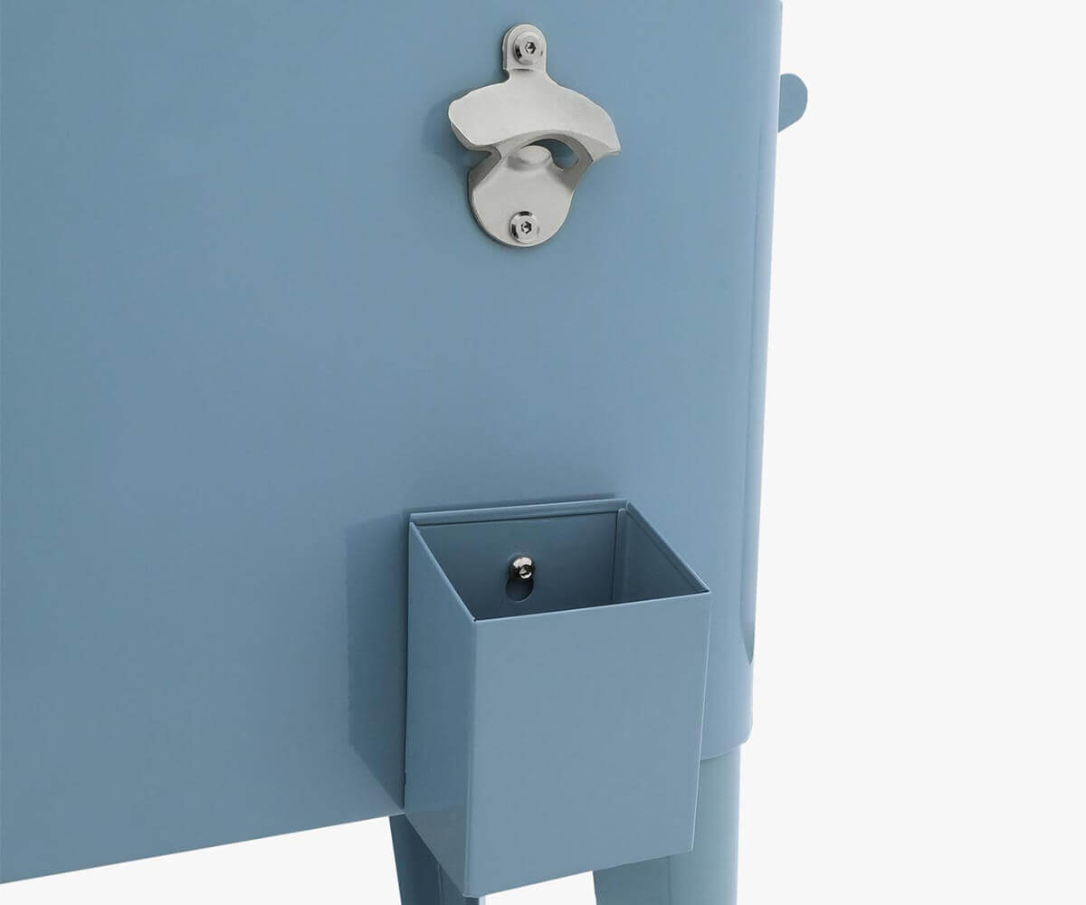 Detailed close-up of the Permasteel 80qt cooler’s front panel in a glossy light-blue colour. The stainless steel bottle opener and small square cap catcher tray are mounted on the side for convenience. The smooth, powder-coated steel surface and chrome hardware highlight its practical and durable outdoor construction designed to complement patios, decks, and poolside areas.