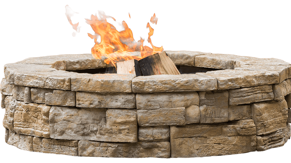 Isolated angled product image of the Rosetta® Belvedere Fire Pit on a transparent background, showing its detailed circular design and realistic stone texture. The pit is composed of hand-crafted-look precast concrete blocks in warm sandy-beige tones with deeply grooved and layered surfaces resembling natural limestone. A black steel fire ring sits inside, framing orange flames and burning logs at the centre. Shadows highlight the curvature and depth of each stone block, illustrating the high-quality craftsmanship. The transparent background focuses attention solely on the fire pit’s design — a statement piece that invites you to settle in for a summer of backyard serenity.