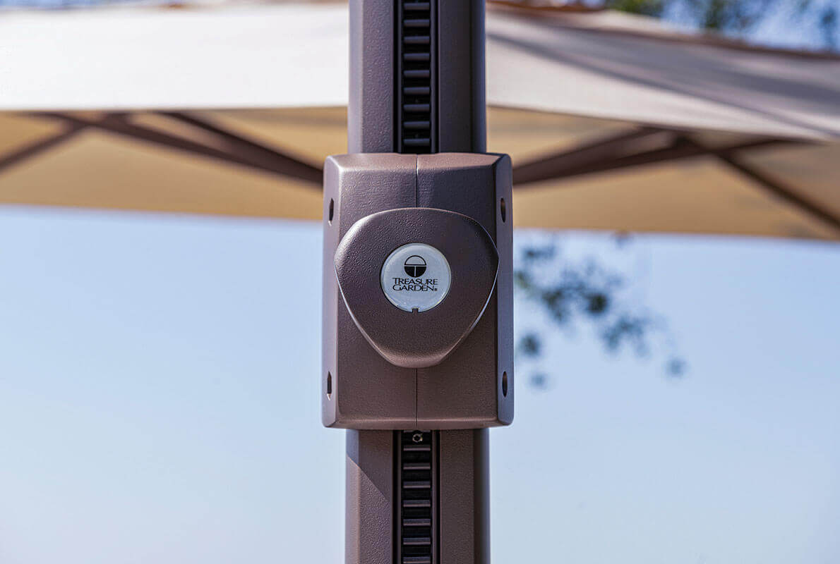 Close-up of the AG25T Umbrella’s height-adjustment track on the vertical mast. The bronze housing features the Treasure Garden logo in the centre, surrounded by fine detailing and riveted edges. The vertical track extends along the pole, allowing smooth sliding for umbrella height adjustment while maintaining the clean, contemporary design.