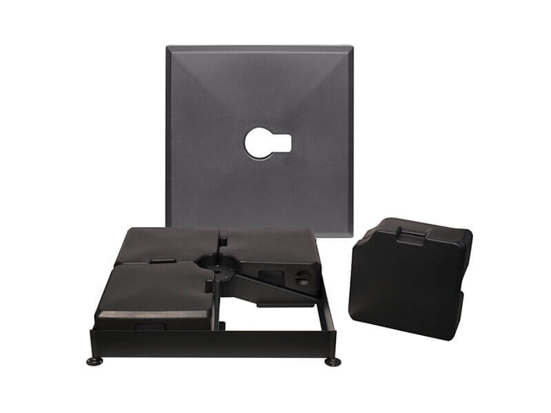 Detailed view of the internal components of the AKZ Sand-Filled Resin Base showing the black steel support frame with four removable hollow weight containers designed to be filled with sand for ballast. The central mounting hub connects to the umbrella post, while the outer square resin lid with a circular cut-out rests behind the frame. One detached weight is displayed to the right, illustrating the modular structure and easy assembly of the base’s stabilising system.