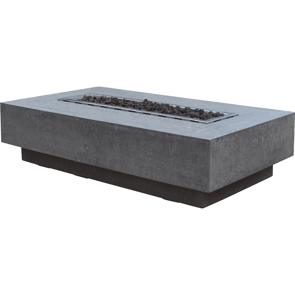 A product isolated view of the Hampton fire table shot on a clean white background. The table has a rectangular shape with a stepped base and a textured light grey glass fibre reinforced concrete finish. The stainless steel burner tray is visible at the centre, filled with reddish brown lava rocks, but unlit. The edges of the table show subtle variations in surface texture, highlighting its handcrafted construction.