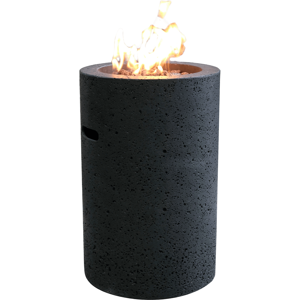 A clean isolated product view of the Lava Tube Fire Pit showing its tall black cylindrical form with a heavily textured glass fibre reinforced concrete exterior. The recessed top burner is filled with a mixture of red and black lava rocks through which a tall yellow orange flame rises. A single elongated side vent is visible on the upper portion of the cylinder. The simple backdrop highlights the vertical proportions, circular top opening, lava rock bed, and upward flame movement.