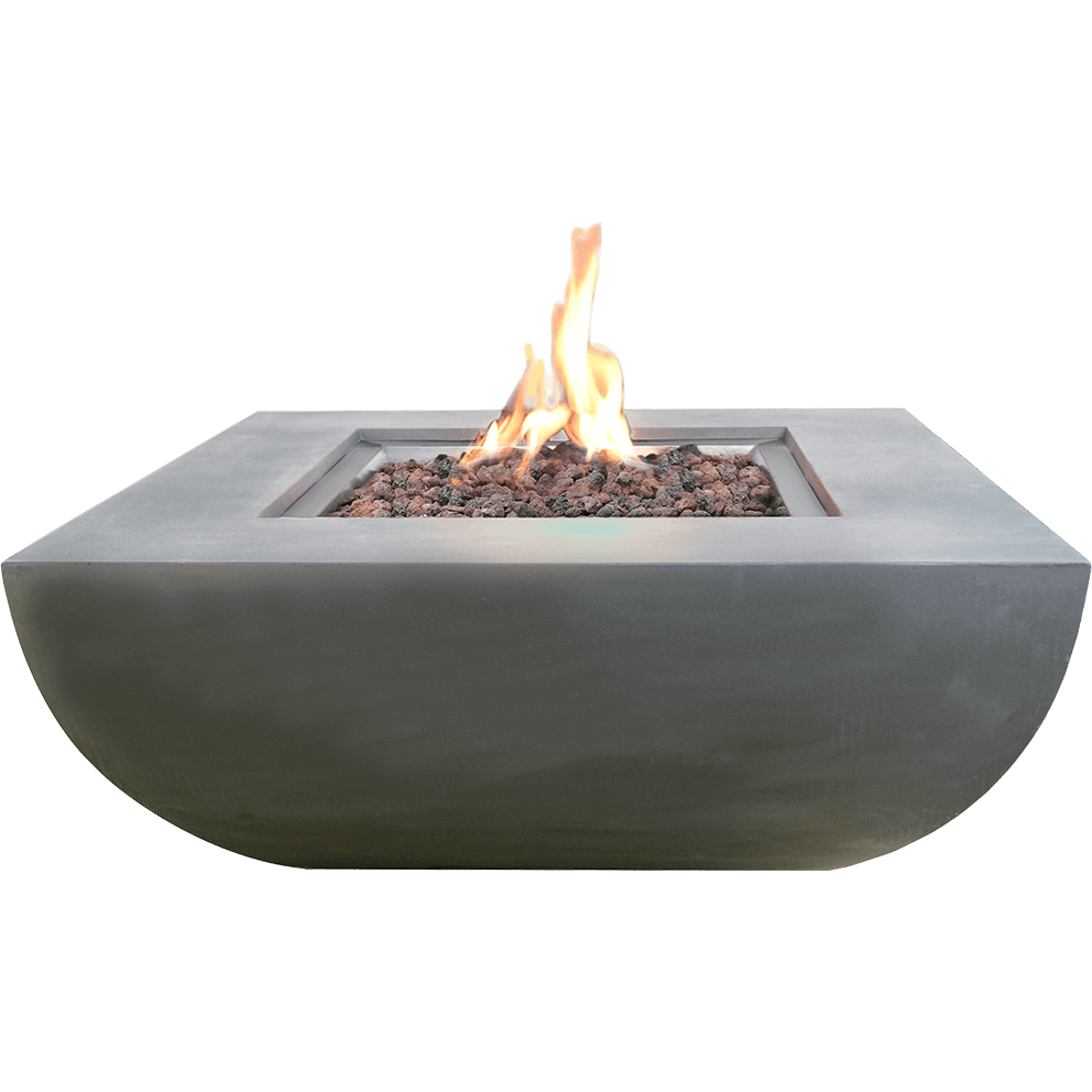 A clean, studio-style front view of the Modeno Westport Fire Table, showing its smooth light grey concrete body with a subtly curved lower section. The central square burner is filled with reddish and charcoal-toned lava rocks, with a tall, bright flame rising from the centre. The overall shape appears wide and sturdy, emphasising the fire table’s modern minimalist silhouette.