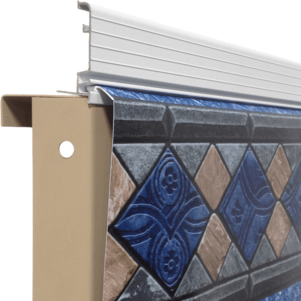 Close-up corner detail of the Fox Ultimate Pool showing the Aluminum Bullnose coping option. The image highlights a smooth, light grey aluminium cap with a rounded bullnose profile running along the top edge of the pool wall. The aluminium coping sits above the decorative liner track and vinyl liner, providing a clean, modern transition at the pool rim. The metal surface appears smooth and slightly matte, with crisp edges designed to protect the liner while creating a sleek, contemporary finish.