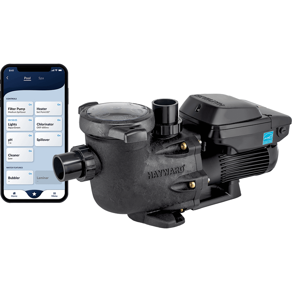 Angled product image of a Hayward TriStar VS 950 Omni pool pump shown isolated on a transparent background, accompanied by a smartphone displaying the Hayward Omni automation interface. The pump is viewed from the front left at a three quarter angle, showing the black strainer housing with a clear locking lid at the front, a horizontal intake union, and a vertical discharge outlet rising from the top of the volute. The motor extends to the right with deep cooling fins and a top mounted digital control module. To the left of the pump, a smartphone screen displays the Omni automation app with clearly segmented controls for pool functions such as filter pump, heater, lights, chlorinator, and water features, illustrating remote speed control, scheduling, and system management. The combined image emphasises advanced automation compatibility, smart control integration, and energy efficient variable speed operation.