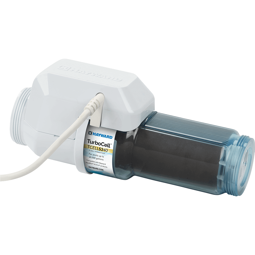 Angled three quarter view of the Hayward TurboCell S340 40,000 Gallons Clear Salt Cell (TCELLS340) on a transparent background, with the white housing positioned toward the upper left and the translucent blue tinted clear chamber extending to the right. A light coloured power cable exits from the top of the housing and arcs diagonally down and left out of frame, indicating the electrical connection point. The internal electrode stack is visible through the clear body as a dark rectangular core, and the ribbed texture along the top of the chamber catches light. The centred label area shows the Hayward logo and “TurboCell” branding, partially turned toward the viewer, while the threaded connection ends are visible at both extremes, with the right end’s clear collar facing slightly toward the camera.