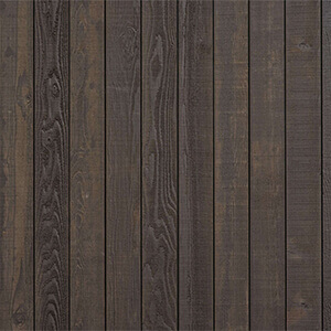 Close-up view of the Blacksmith painted red cedar exterior wood material for the Visscher Luxe Sauna, featuring vertically aligned cedar planks finished in a deep charcoal-brown stain. The surface reveals pronounced woodgrain patterns with visible knots, swirling grain lines, and subtle tonal variations ranging from dark espresso to muted grey undertones. The painted finish retains the natural texture of the cedar while adding a rich, weathered appearance, creating a bold, modern exterior aesthetic with a rustic edge.
