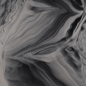 Close-up view of the Odyssey acrylic colour option for Cal Spas hot tubs, swim spas, and cold plunges, showcasing a striking monochromatic blend of black, charcoal, and soft silver-grey tones. The surface features dramatic, fluid marbling with sweeping, layered patterns that resemble swirling stone or flowing ink. High-contrast transitions between light and dark areas create depth and movement, while fine veining and soft gradients add intricate detail. The glossy acrylic finish enhances the reflective quality of the surface, resulting in a bold, modern, and sophisticated spa interior aesthetic.